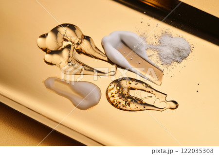 Textures of different cosmetic products on a gold background. 122035308