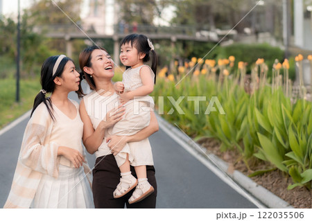 Happy Asian Family Moments in a Park with Children in Natural Light and Colorful Background. 122035506