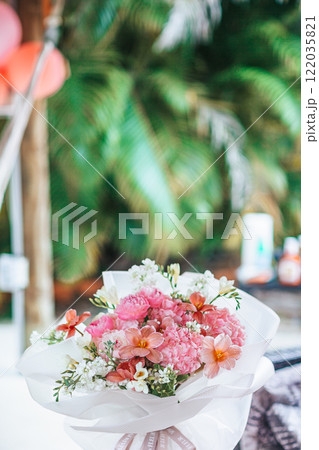 Beautiful bright bouquet of peony on the wedding table in vase Beautiful bright bouquet of peony on the wedding table in vase 122035821
