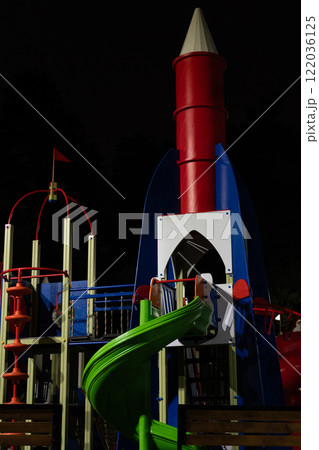 Playground at night in the park under a street lamp Playground at night in the park under a street lamp 122036125