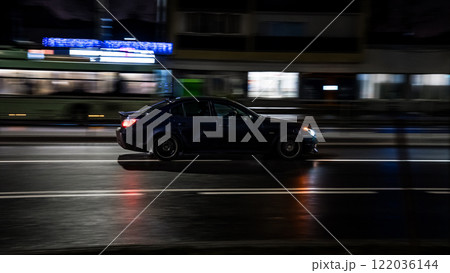 The car drives through the city at night, side view. Motion blur 122036144