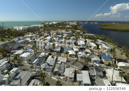 Wind damage of private houses after hurricane swept through Florida mobile home residential area. Consequences of natural disaster 122036546