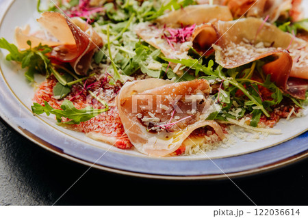 Gourmet salad with prosciutto, arugula, figs, and parmesan, a perfect fusion of flavors Gourmet salad with prosciutto, arugula, figs, and parmesan, a perfect fusion of flavors 122036614