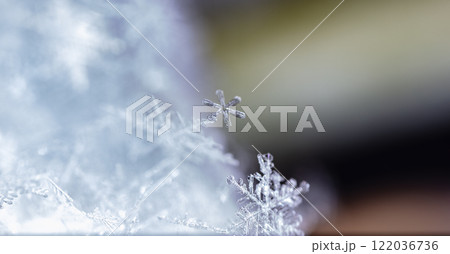 snapshot of a small snowflake taken during a snowfall 122036736