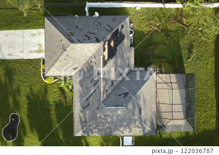 Hurricane Ian destroyed house roof in Florida residential area. Natural disaster and its consequences Hurricane Ian destroyed house roof in Florida residential area. Natural disaster and its consequences 122036787