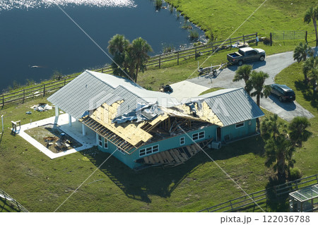 Hurricane Ian destroyed house roof in Florida residential area. Natural disaster and its consequences Hurricane Ian destroyed house roof in Florida residential area. Natural disaster and its consequences 122036788