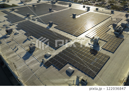 Photovoltaic solar panels mounted on industrial building roof for producing green ecological electricity. Production of sustainable energy concept 122036847