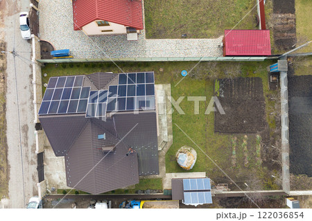 Private home roof covered with solar photovoltaic panels for generating of clean ecological electric energy in suburban rural town area. Concept of autonomous house 122036854
