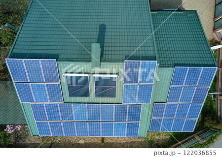 Private home roof covered with solar photovoltaic panels for generating of clean ecological electric energy in suburban rural town area. Concept of autonomous house 122036855