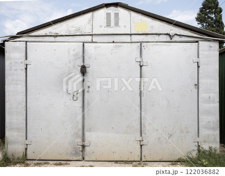 old metal door to the car garage old metal door to the car garage 122036882