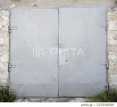 old metal door to the car garage old metal door to the car garage 122036884