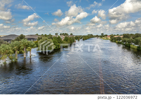 Hurricane Debby flooded city street with trapped car submerged under water in Florida residential area. Consequences of natural disaster Hurricane Debby flooded city street with trapped car submerged under water in Florida residential area. Consequences of natural disaster 122036972