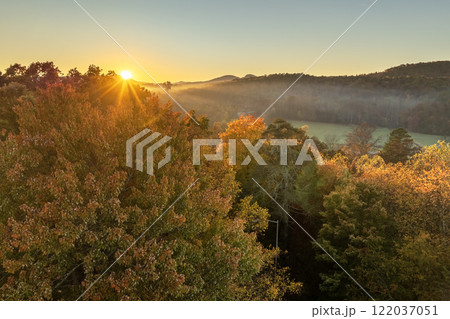 Colorful mountain forest with yellow canopies in autumn at sunset. Landscape of wild woods nature in fall season Colorful mountain forest with yellow canopies in autumn at sunset. Landscape of wild woods nature in fall season 122037051