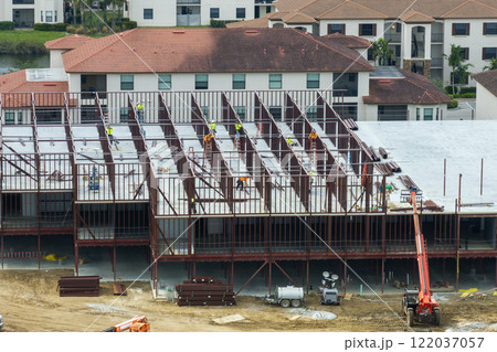 Construction site with many workers and equipment in Fort Myers, Florida. Hard labor employment at commercial development Construction site with many workers and equipment in Fort Myers, Florida. Hard labor employment at commercial development 122037057