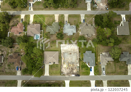 Aerial view of suburban private house wit wooden roof frame under construction in Florida quiet rural area 122037245