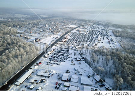 Aerial view of vehicle open market lot with many cars for sale parked and people customers walking in winter 122037265