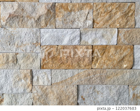 Close-up of a stone wall showcasing various earthy tones and textures. Background for text or copy space and empty space for advertising Close-up of a stone wall showcasing various earthy tones and textures. Background for text or copy space and empty space for advertising 122037683