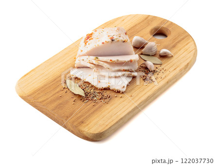 Salted lard with spices on a cutting board. 122037730