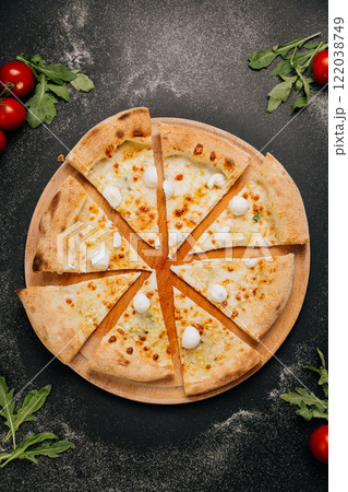 Cheesy pizza slices topped with mini mozzarella, ready to share for the perfect food moment 122038749