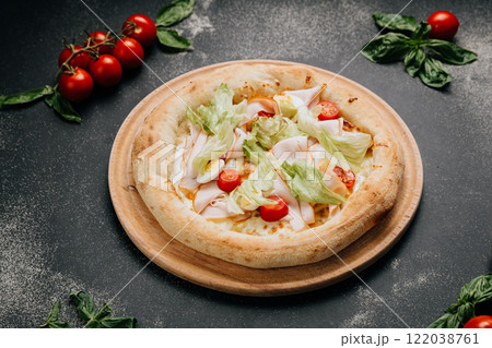 Fresh salad pizza with turkey, lettuce, cherry tomatoes, and egg slices on a wooden board 122038761