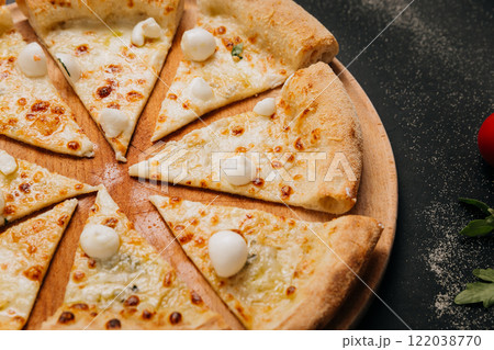 Cheesy pizza slices topped with mini mozzarella, ready to share for the perfect food moment 122038770