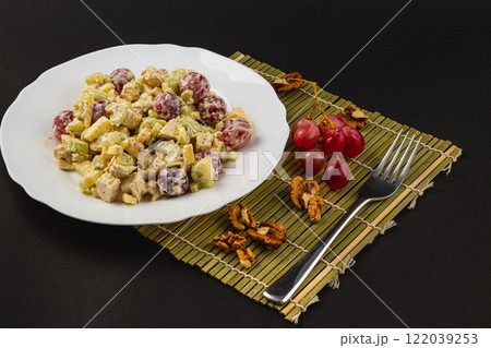 Colorful salad featuring almonds and red beets served on a decorative mat 122039253