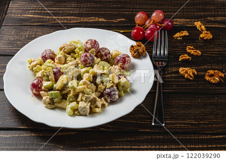 Colorful salad featuring almonds and red beets served on a decorative mat 122039290