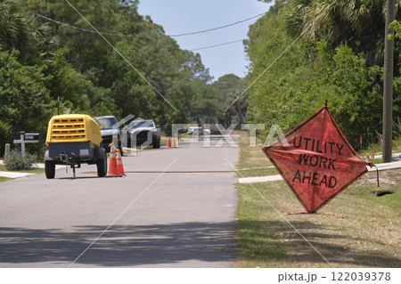 Road work ahead sign on street site as warning to cars about construction and utility works Road work ahead sign on street site as warning to cars about construction and utility works 122039378