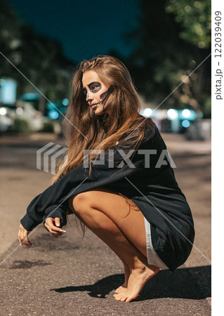 Portrait of creepy teenage girl with Halloween makeup 122039409
