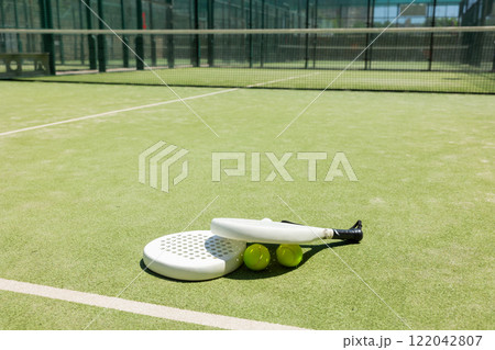 Rackets and balls for playing padel on an outdoor tennis court Rackets and balls for playing padel on an outdoor tennis court 122042807