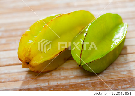 Whole yellow carambolas on wooden table Whole yellow carambolas on wooden table 122042851