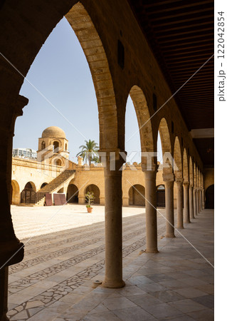 Great mosque in medieval medina of Sousse, Tunisia, Africa. Picturesque courtyard and stairs. Old walls and arches Great mosque in medieval medina of Sousse, Tunisia, Africa. Picturesque courtyard and stairs. Old walls and arches 122042854