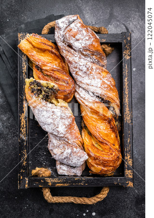 Roll pastry with Pistachios and chocolate, Danish Puff pastry. black background. top view Roll pastry with Pistachios and chocolate, Danish Puff pastry. black background. top view 122045074