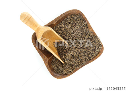 Caraway seeds in wooden bowl with scoop on white background 122045335