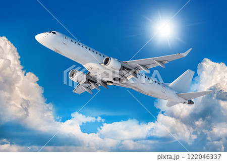 White passenger aircraft is climbing in the air above scenic clouds 122046337
