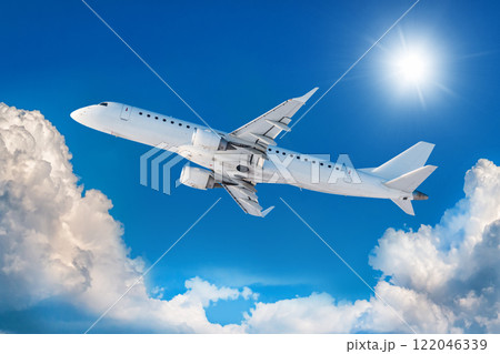 White passenger airliner fly in the air above scenic clouds White passenger airliner fly in the air above scenic clouds 122046339