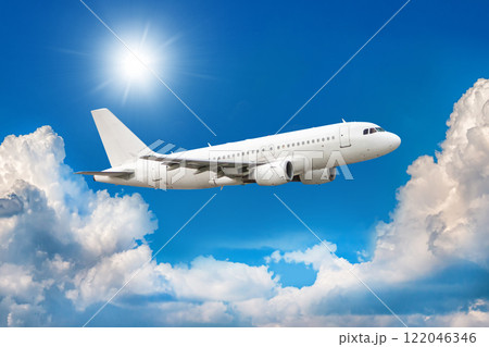 White passenger aircraft is climbing in the air above scenic clouds 122046346