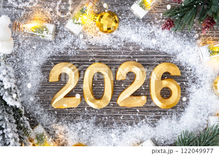 Happy New Year golden numbers 2026 on cozy festive grey wooden background with Christmas tree, snow, lights of garlands. Greetings, postcard. Calendar, cover Happy New Year golden numbers 2026 on cozy festive grey wooden background with Christmas tree, snow, lights of garlands. Greetings, postcard. Calendar, cover 122049977