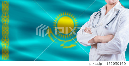 Doctor with crossed arms on Kazakhstan flag. Kazakhstan Health and Care concept. Female doctor on Kazakhstan flag 122050160