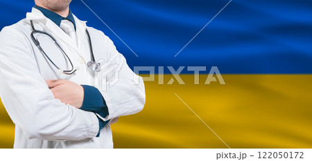 Ukraine Health Care concept. Male doctor on Ukraine flag. Doctor with crossed arms on Ukraine flag 122050172