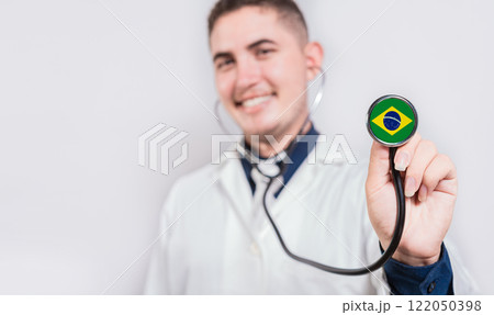Brazil National Healthcare concept. Smiling doctor showing stethoscope with Brazil flag 122050398