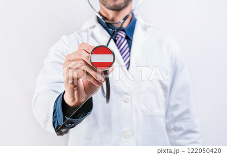 Austria Healthcare System, doctor holding stethoscope. Austria health and medical insurance concept 122050420