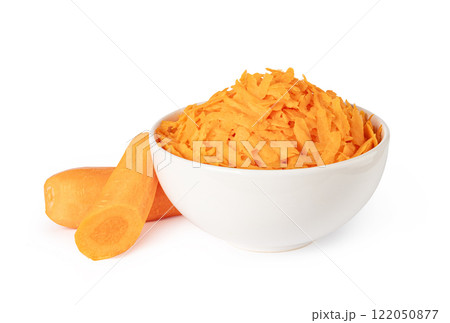 Grated carrots in a white bowl with fresh carrots 122050877
