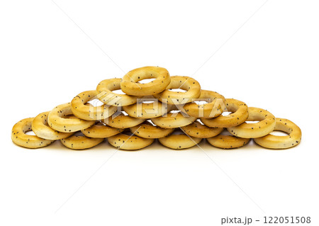 On a white background a bagel with poppy seeds stacked on a white background On a white background a bagel with poppy seeds stacked on a white background 122051508