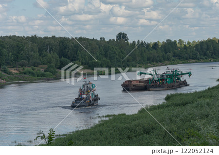 Chernihiv, Ukraine - 07/12/2018: ship and barge on the riverbed Chernihiv, Ukraine - 07/12/2018: ship and barge on the riverbed 122052124