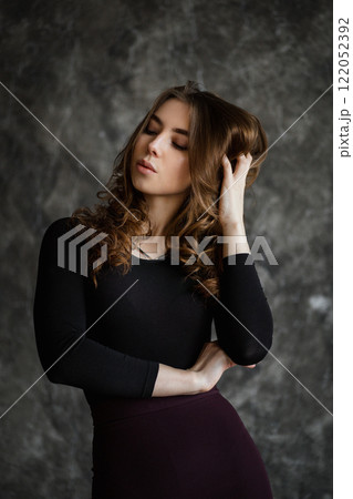 Captivating portrait of a woman expressing grace and elegance in a thoughtfully designed studio setting Captivating portrait of a woman expressing grace and elegance in a thoughtfully designed studio setting 122052392