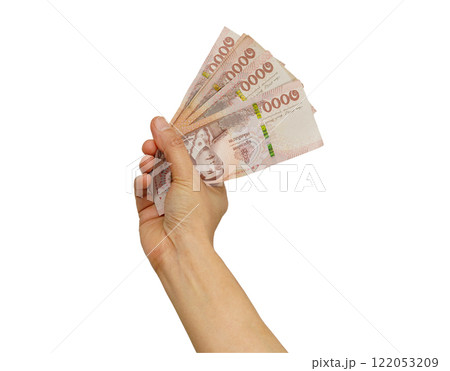 Asian woman counting Thai baht banknote money and holding in hand isolated on white background. 122053209