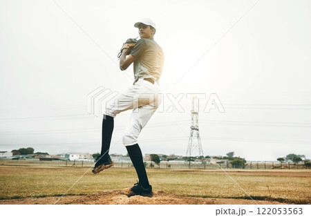 Baseball player, pitch and sports athlete man outdoor on a field with focus and fitness. Game training, exercise and team workout of a strong person playing baseball ready for cardio and exercising 122053563