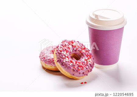 A cheerful display of donuts and a paper coffee cup on a white background A cheerful display of donuts and a paper coffee cup on a white background 122054695