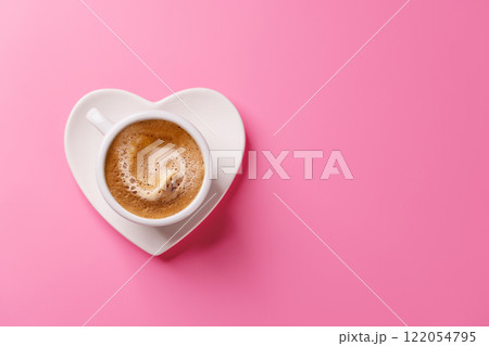 A charming coffee cup placed on a heart-shaped saucer 122054795